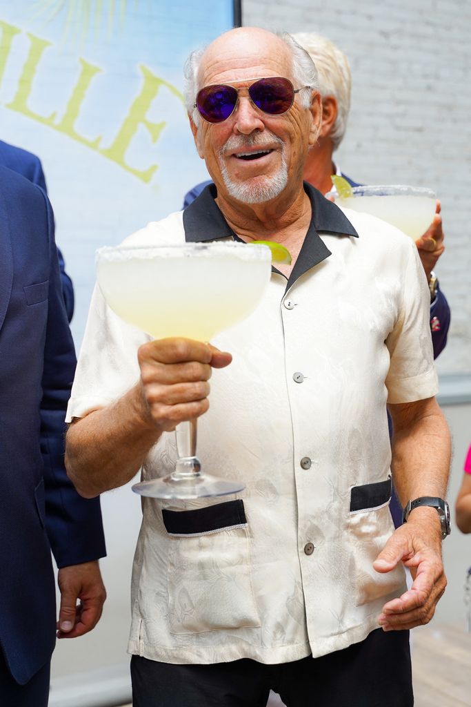Jimmy Buffett holds an oversized glass of margarita