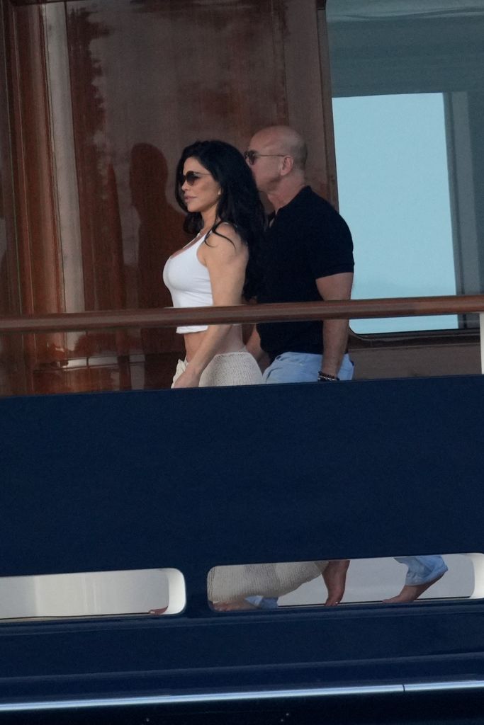 Jeff Bezo walks alongside his girlfriend Lauren Sanchez