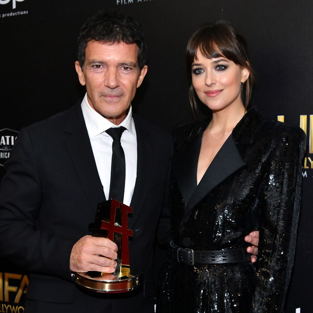 Antonio Banderas, winner of the Hollywood Actor Award, and Dakota Johnson pose in the press room during the 23rd Annual Hollywood Film Awards at The Beverly Hilton Hotel on November 03, 2019 in Beverly Hills, California