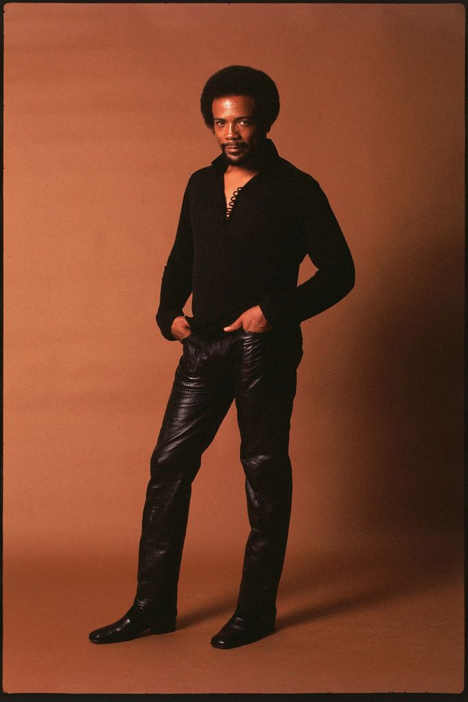 Photo of Quincy JONES; Posed full length studio portrait of Quincy Jones, leather trousers