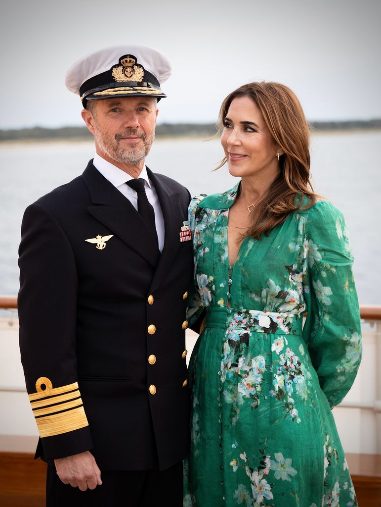 Queen Mary in green dress looking at King Frederik in naval uniform