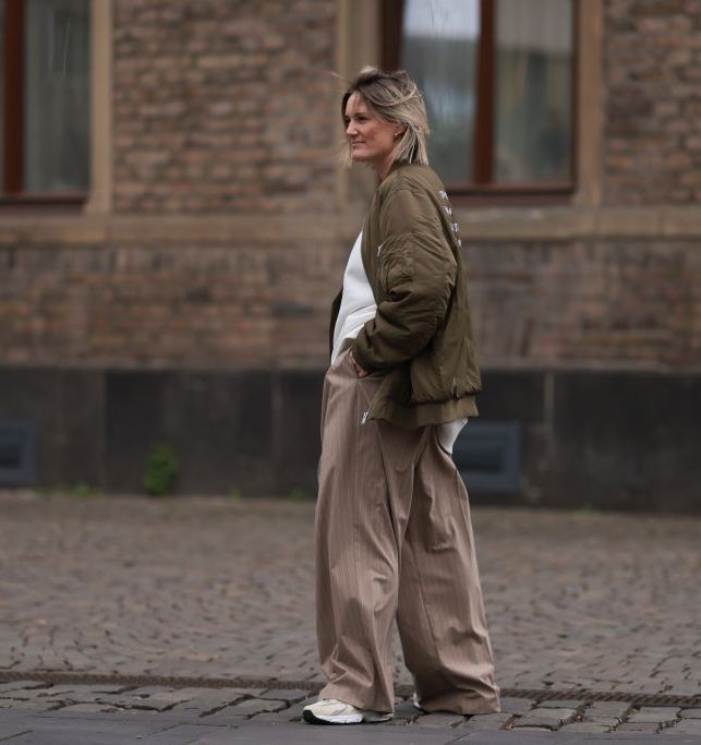  Influencer Victoria Thomas teams her New Balance 530s with wide leg trousers and a bomber jacket