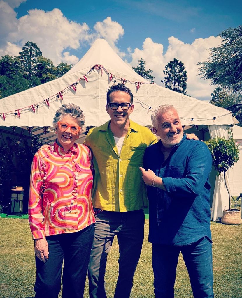 Ryan Reynolds stands in between Prue Leith and Paul Hollywood
