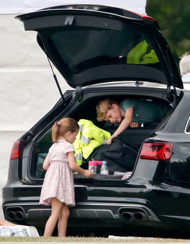 Prince George leaning through back of car 