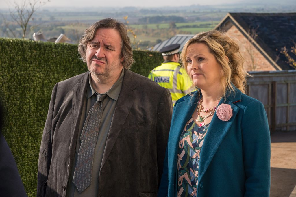 man and woman standing outdoors