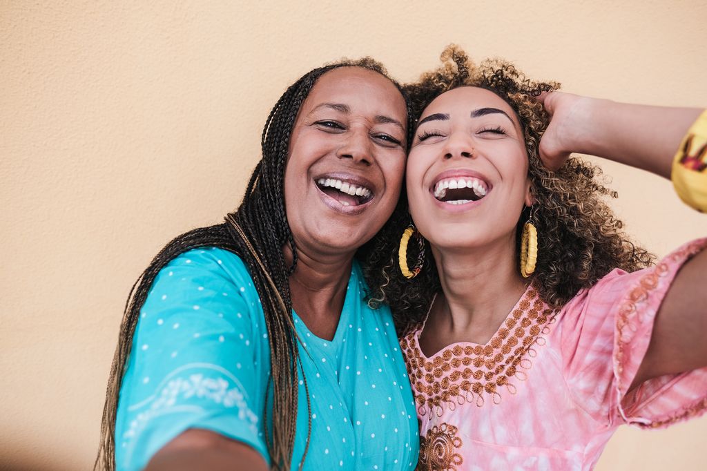 Two women smiling and laughin 