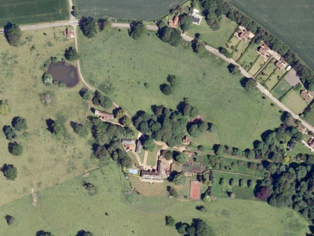 Aerial view of Anmer Hall with a swimming pool and tennis court