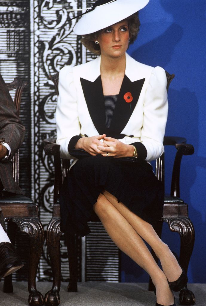 Princess Diana sat in black and white outfit with hat
