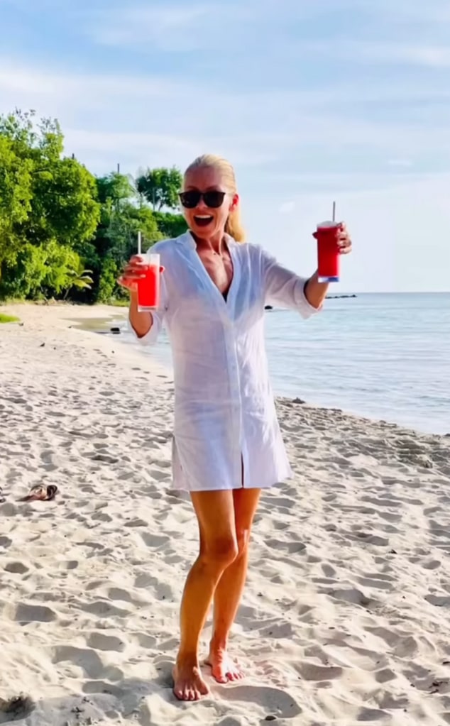 Clip of a video montage shared by Kelly Ripa shared on Instagram September 2023 where she walking on the beach with drinks in her hands during their beach vacation with their kids.