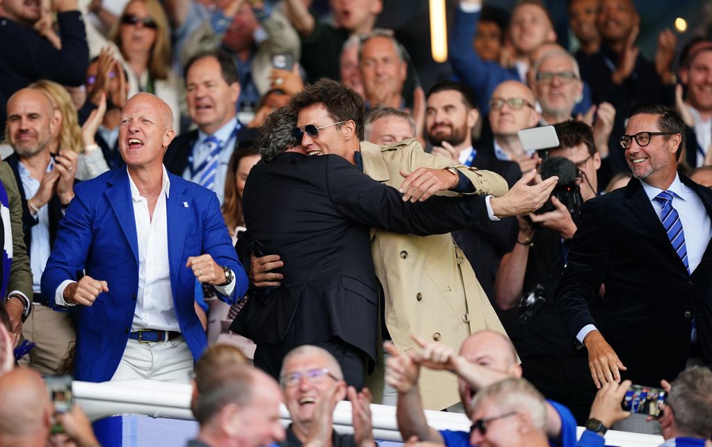 Birmingham City CEO Garry Cook hugs co-owner Tom Brady as the soccer team celebrate their goal