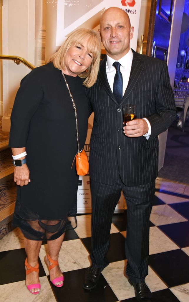 Linda Robson in black dress and Mark Dunford in suit