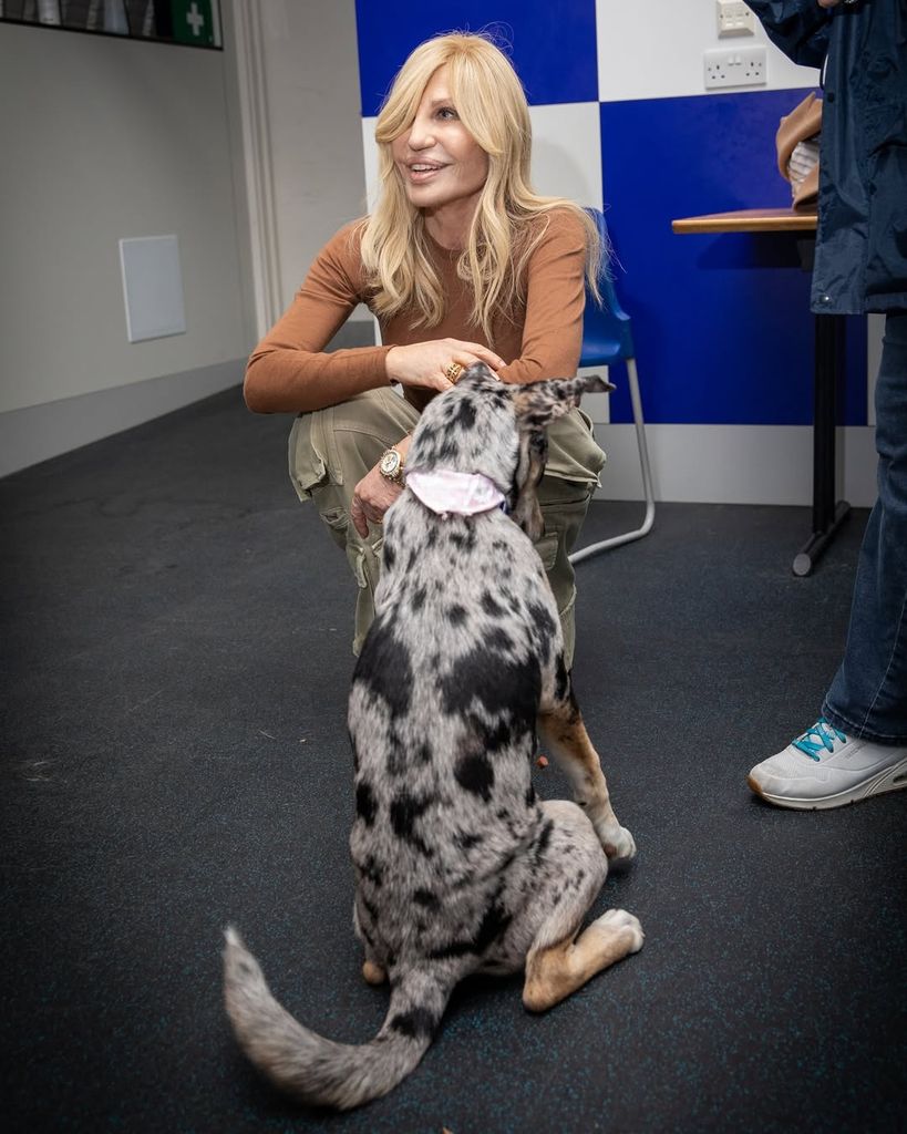 Donatella had a youthful glow while visiting an animal shelter