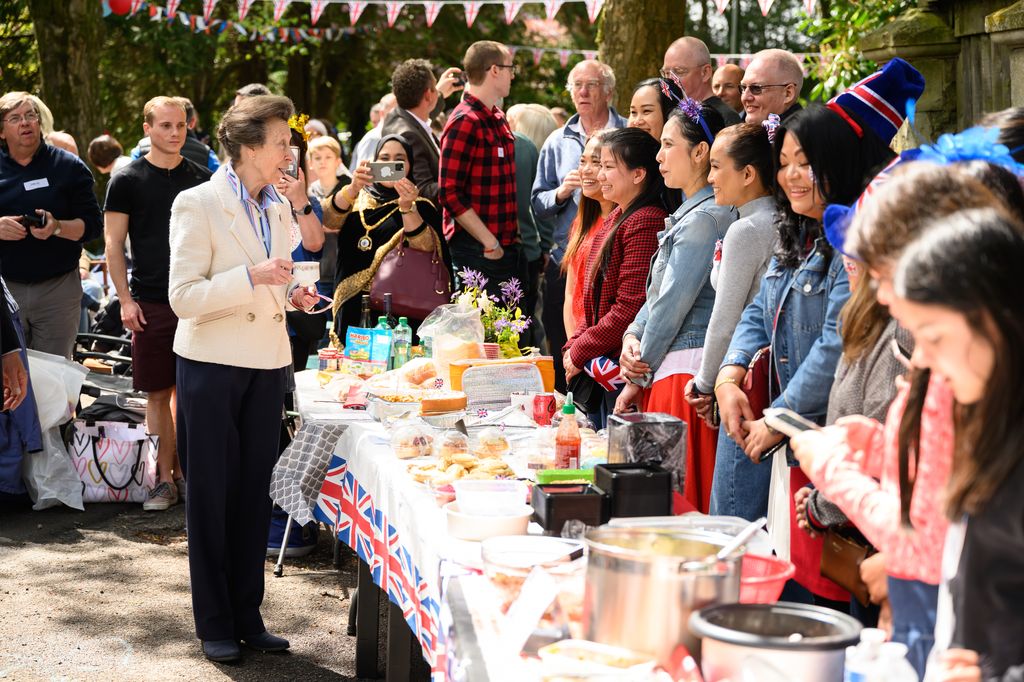 Princess Anne speaks with residents as they hold a Coronation street party