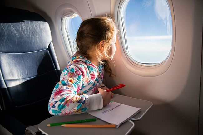 girl colouring on plane