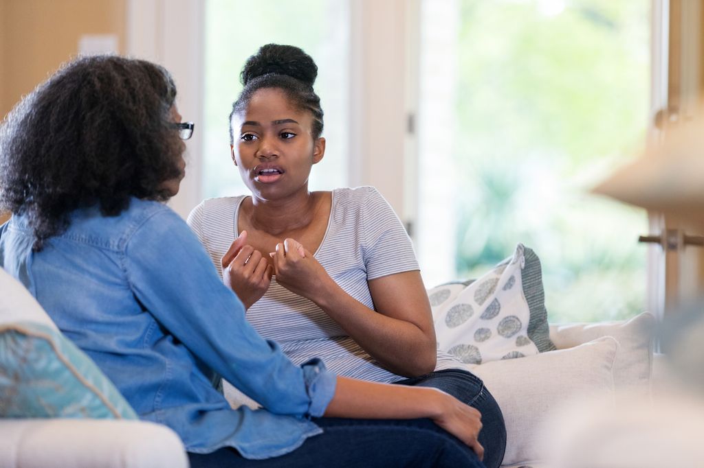 teen talking to mum on sofa