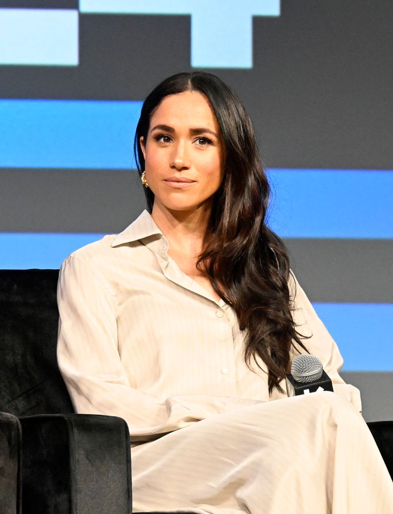 Meghan Markle in cream outfit on stage
