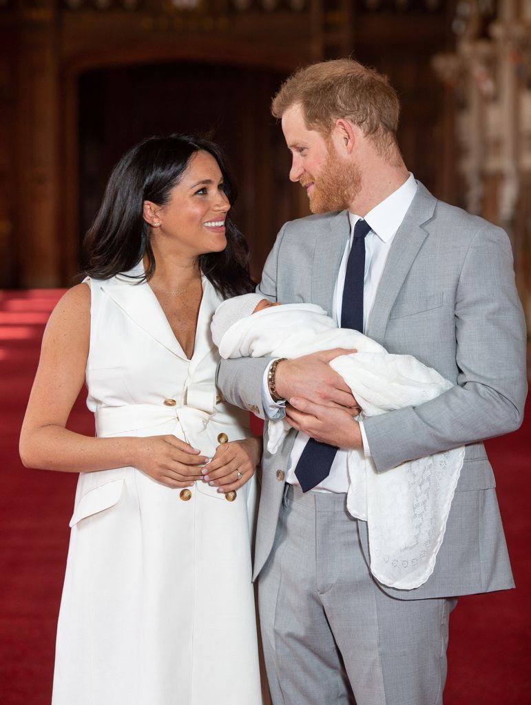 Prince Harry, Duke of Sussex, and his wife Meghan, Duchess of Sussex, pose for a photo with their newborn baby son, Archie Harrison Mountbatten-Windsor, in St George's Hall at Windsor Castle in Windsor, west of London on May 8, 2019.