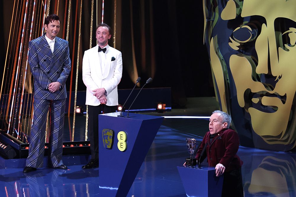 Warwick Davis on stage after receiving the BAFTA Fellowship on Sunday night