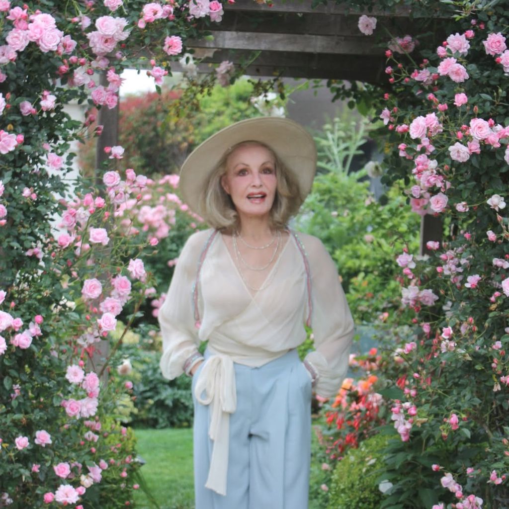 Julie Newmar poses for a photo in the garden of her Los Angeles home, shared on Instagram