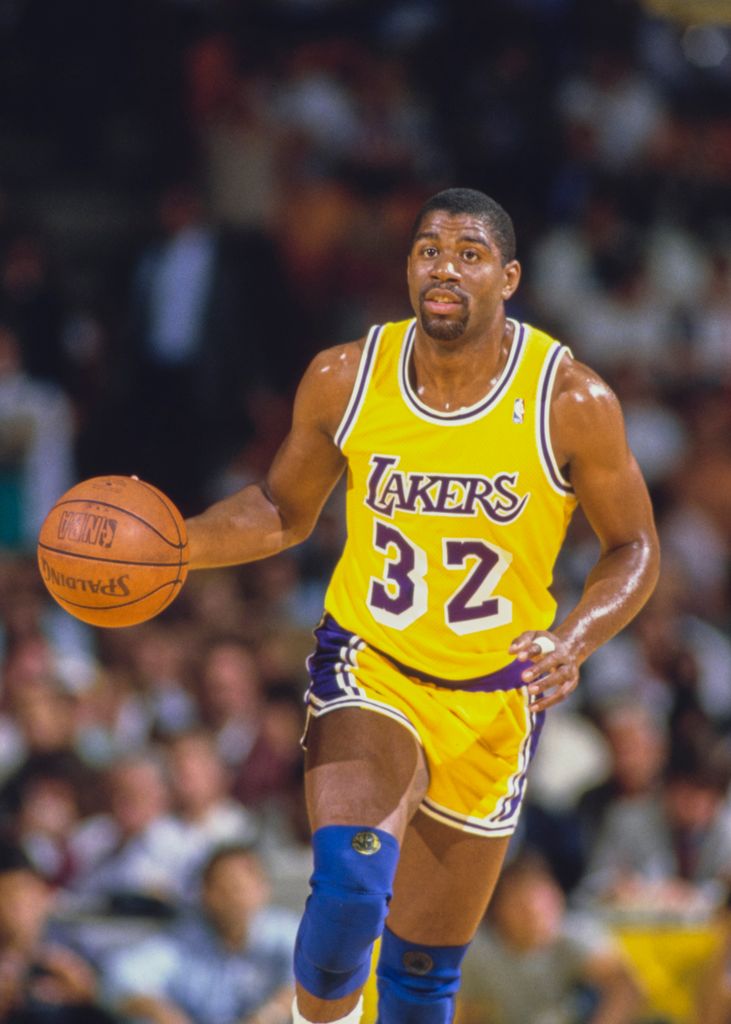 Earvin "Magic" Johnson #32, Shooting Guard and Power Forward for the Los Angeles Lakers takes the basketball down court during the NBA Pacific Division basketball game against the Utah Jazz on 18th March 1987 at The Forum arena in Inglewood, Los Angeles, California, United States. The Lakers won the game 111 - 97.