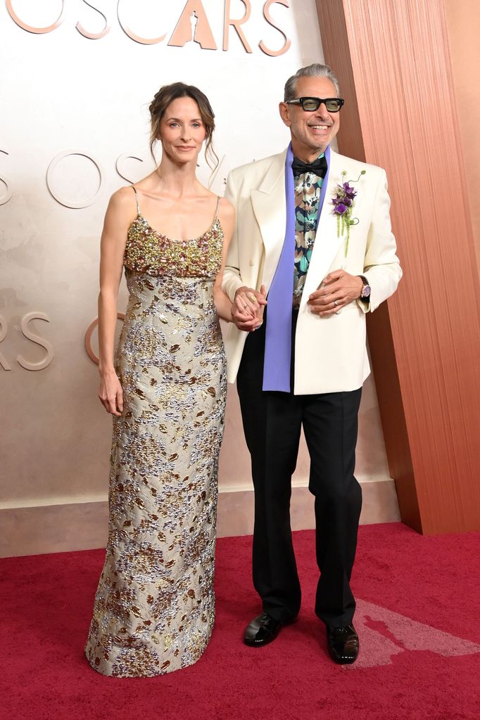 Emilie Livingston and Jeff Goldblum holding hands on the red carpet 97th Annual Academy Awards