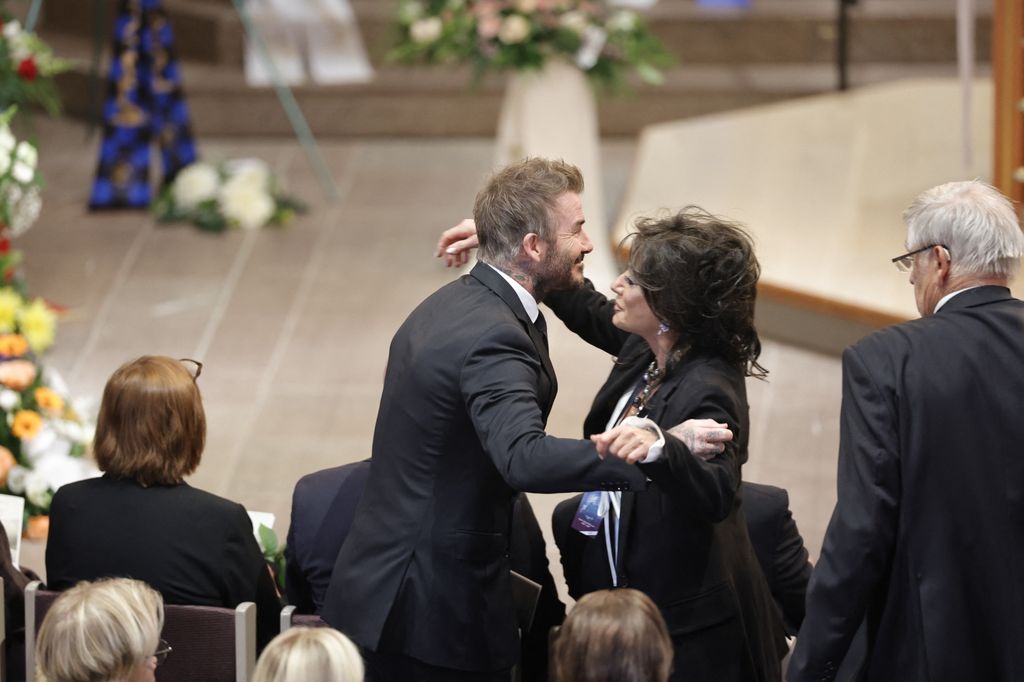 David Beckham and Nancy Dell'Olio hug 