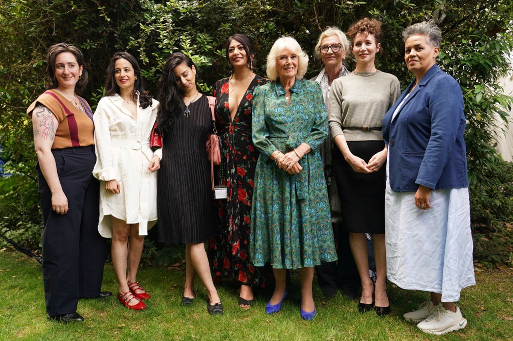 Queen Camilla standing with a group of women