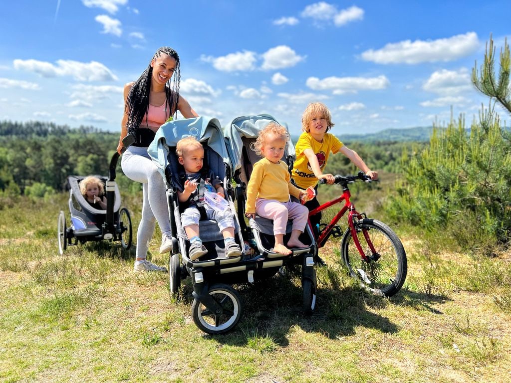 Woman outdoors with four children