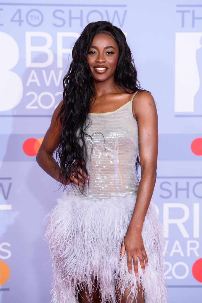 AJ Odudu in feathered dress at the BRIT Awards 