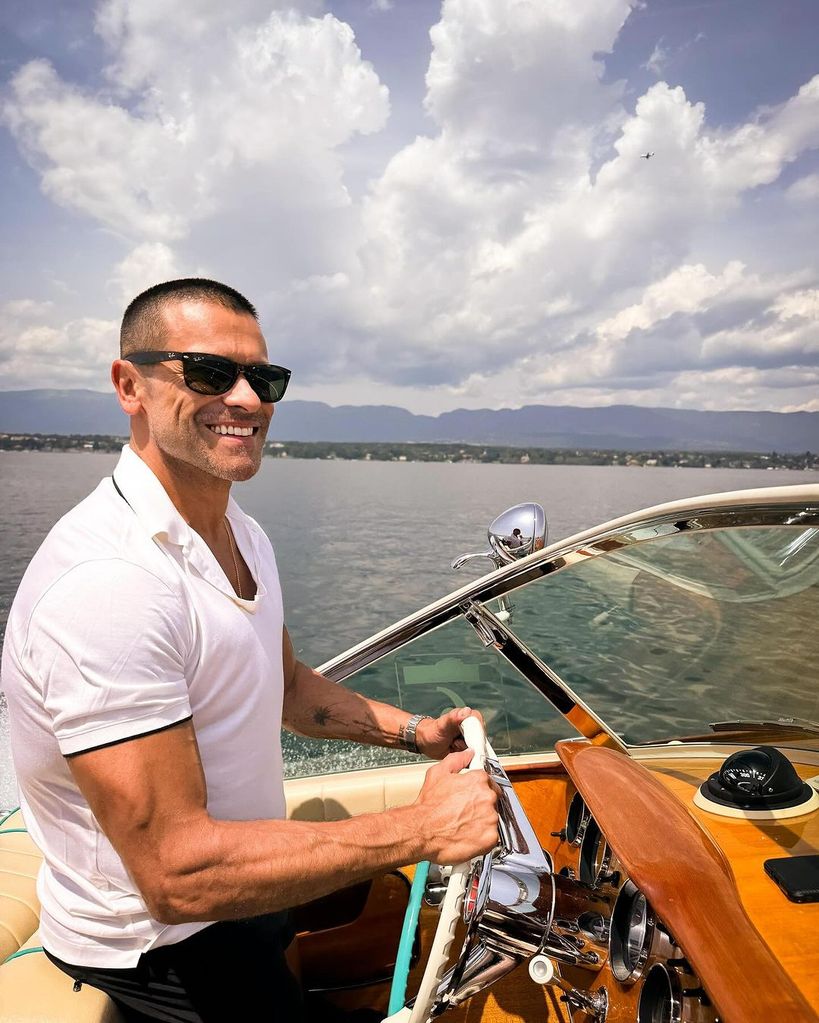 Mark Consuelos takes the helm on a private boat during a family trip to Switzerland