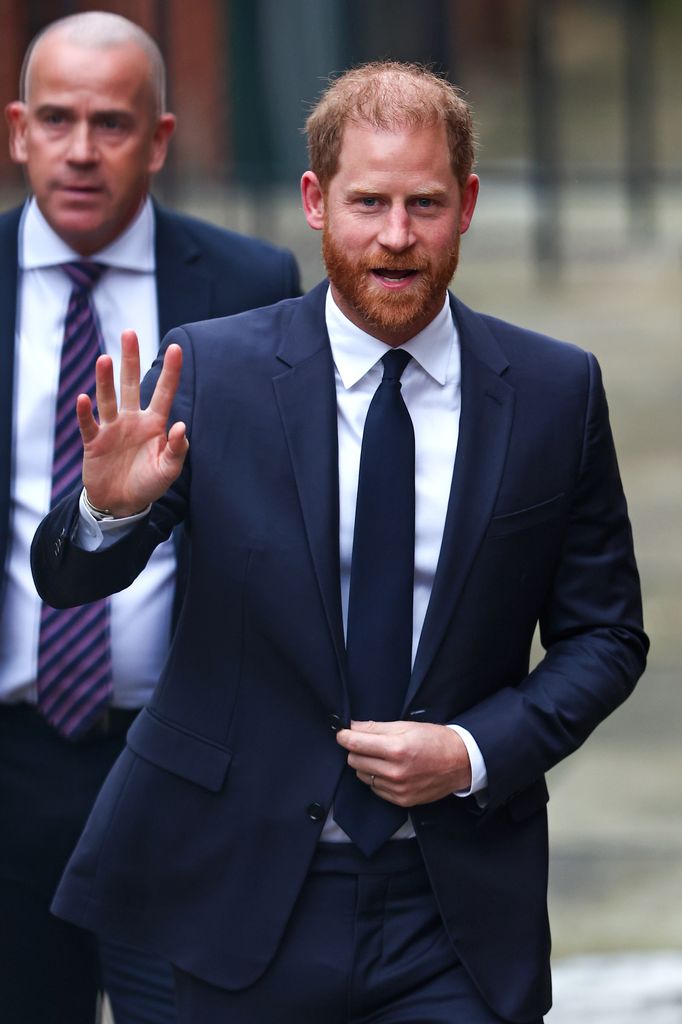 Prince Harry waving in navy suit