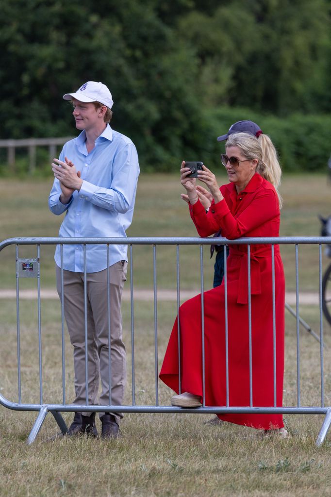 Sophie Duchess of Edinburgh, (red) and Felix da Silva Clamp watching Lady Louise Windsor, who came third in the Sandringham Horse Driving Trials 