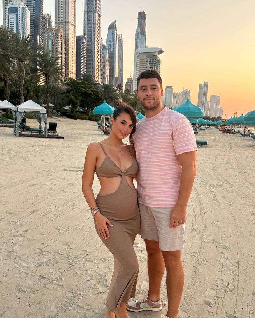 couple posing on beach in Dubai 