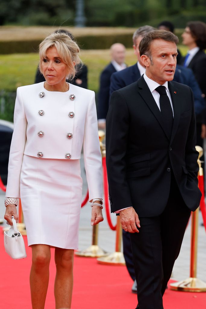 French President Emmanuel Macron and his wife Brigitte Macron arrive to attend a gala dinner hosted by the International Olympic Committee 