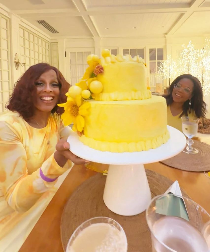 Gayle King and Oprah Winfrey pose with the former's birthday cake at a 71st birthday celebration, shared on Instagram