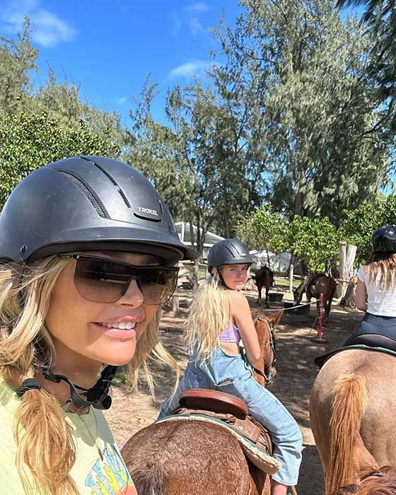 Denise Richards takes a selfie while on a horse, her daughter Sami is riding on another horse in front of her