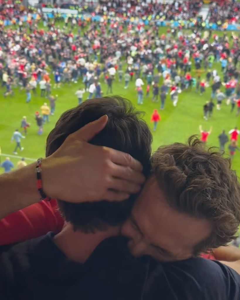 Ryan Reynolds and Rob McElhenney embrace after Wrexham AFC's win against Charlton Athletic F.C. on Saturday, April 26
