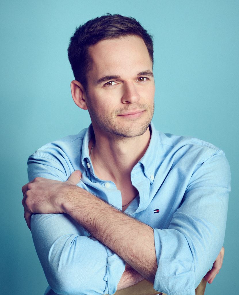 Smart man smiling in a blue shirt