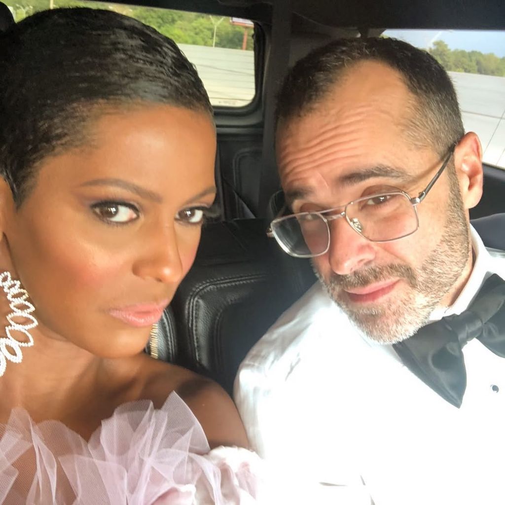 Tamron Hall and Steven Greener smiling in a car