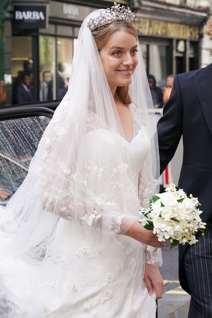 Flora Ogilvy smiling in a wedding dress and tiara