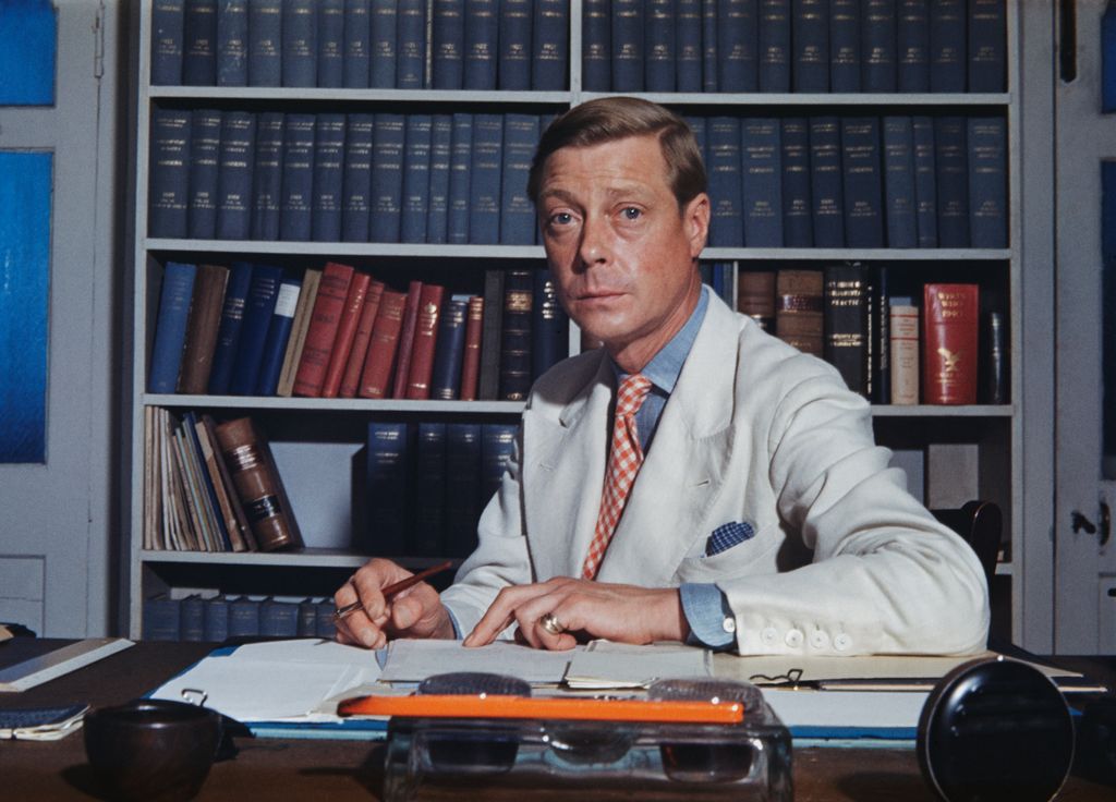 The Duke of Windsor sitting a desk strew with papers