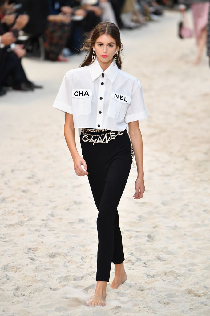 kaia gerber in chanel shirt on sandy beach runway