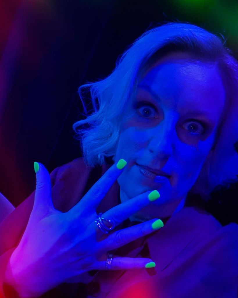 woman showing off glow-in-the-dark manicure