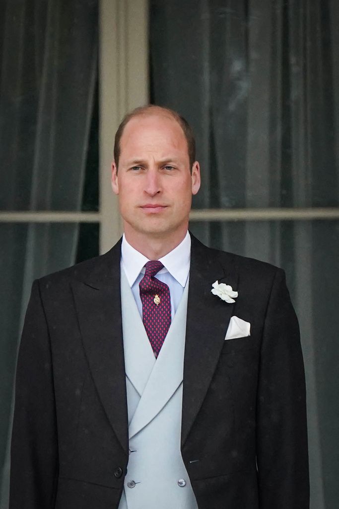 Prince William in black suit and blue waistcoat at Buckingham Palace Garden Party