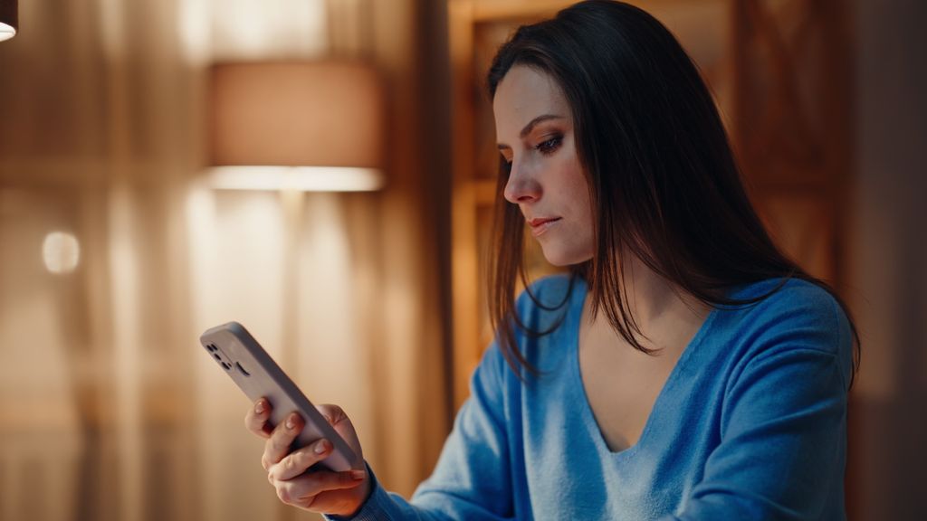 introverted woman looking at mobile phone