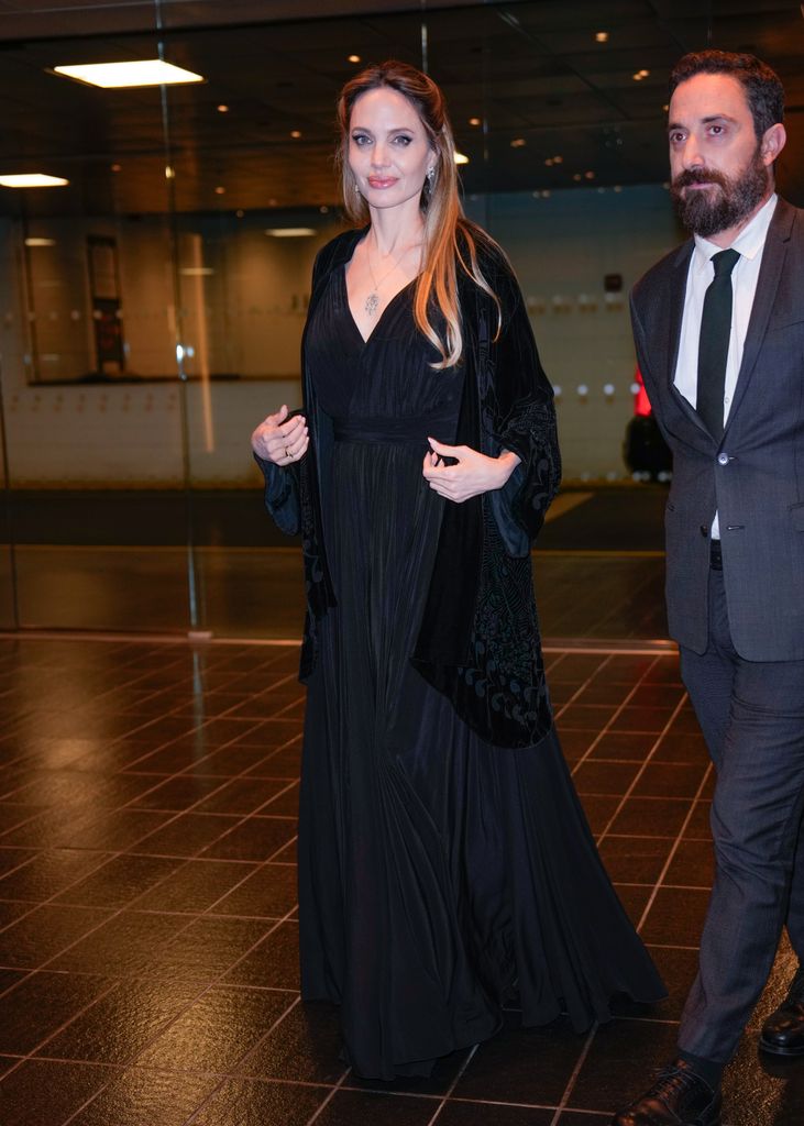 Angelina stunned in a low-neck dress and velour jacket combo