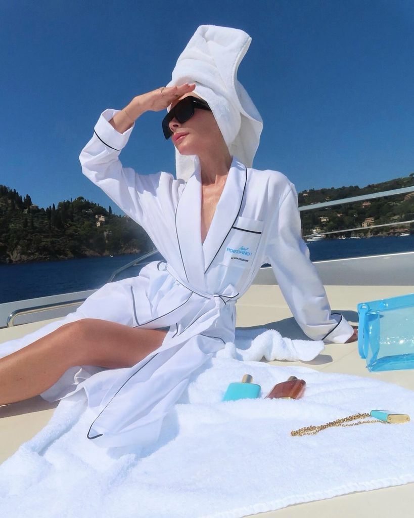 Victoria on a luxury yacht in white robe with towel on head