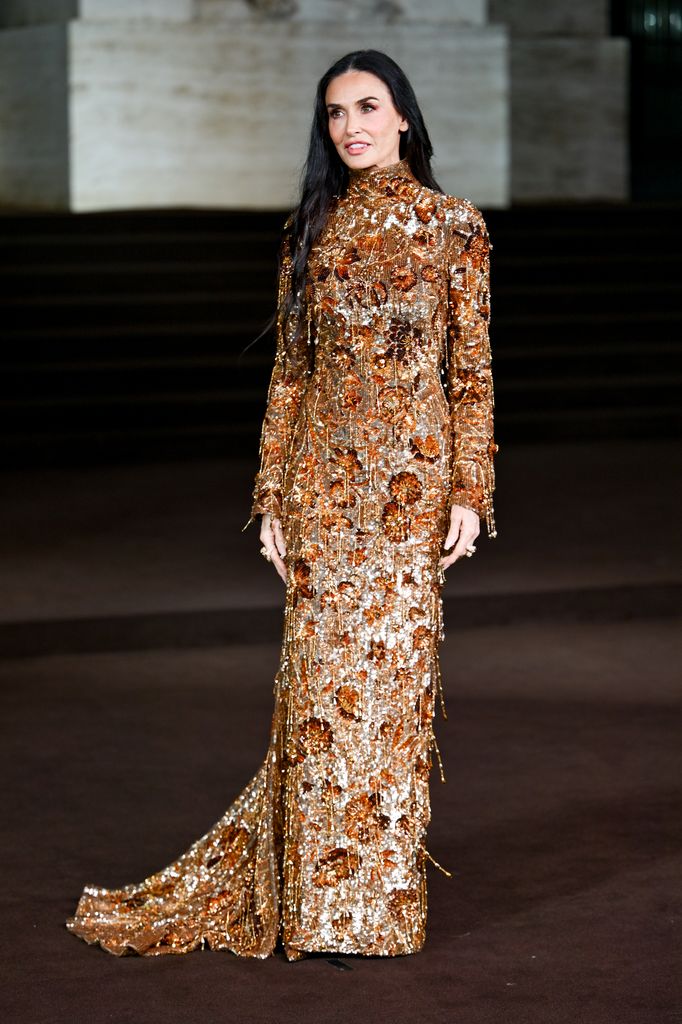 Demi Moore in gold dress at the Gucci fashion show
