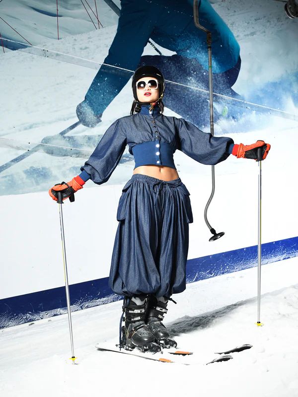 model in denim co ord on skis