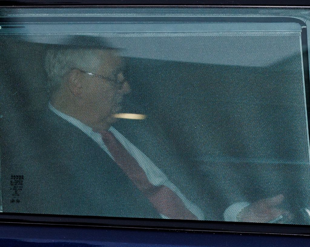 Prince Andrew in the back of a car with covered windows
